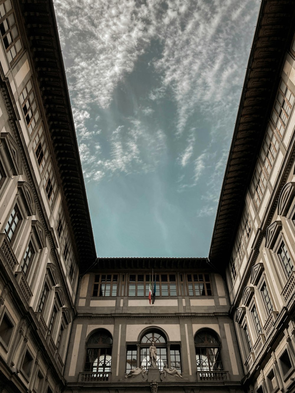 a building with a sky background and a clock