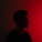 a man standing in front of a red light
