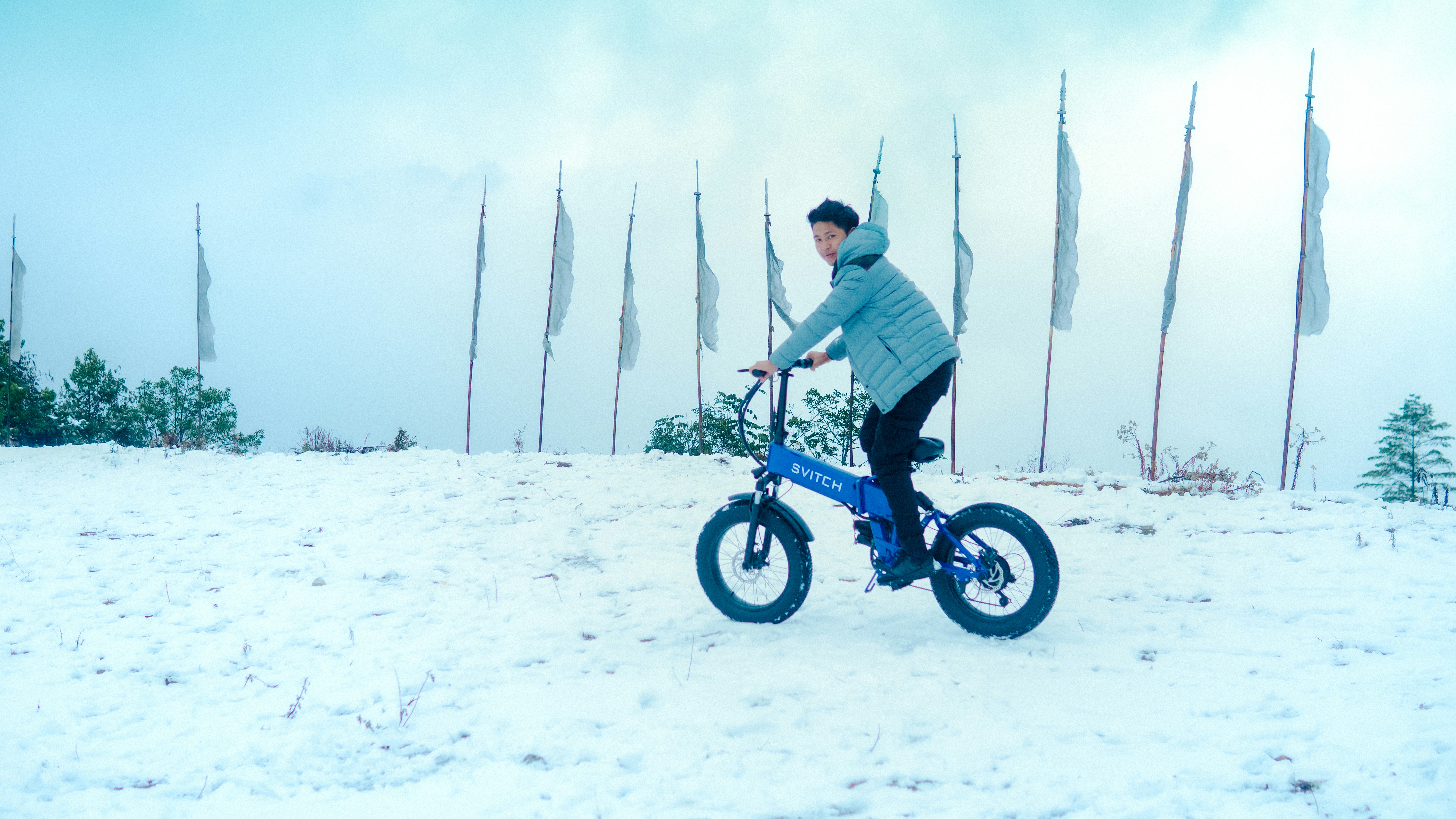 a man riding a bike in the snow