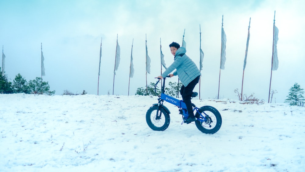 a man riding a bike in the snow