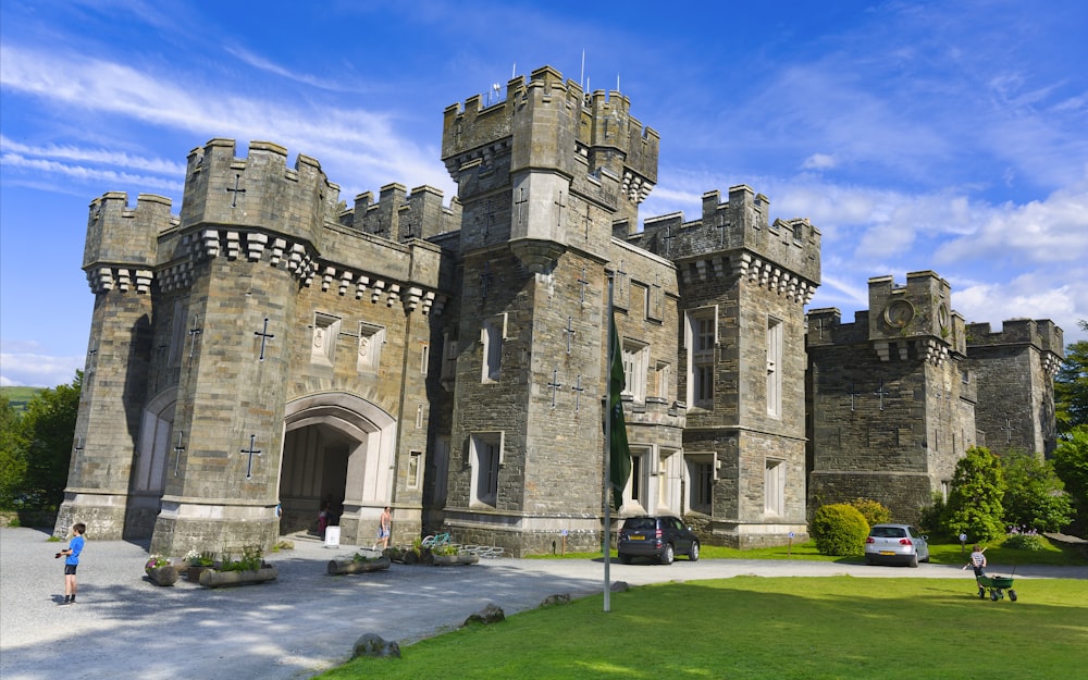 a large castle like building sitting on top of a lush green field