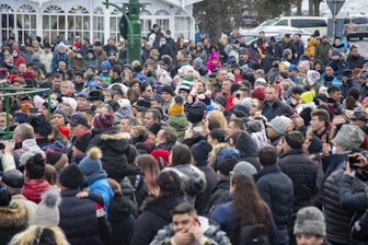 a large crowd of people standing in front of a building