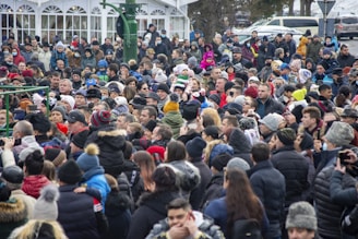 a large crowd of people standing in front of a building
