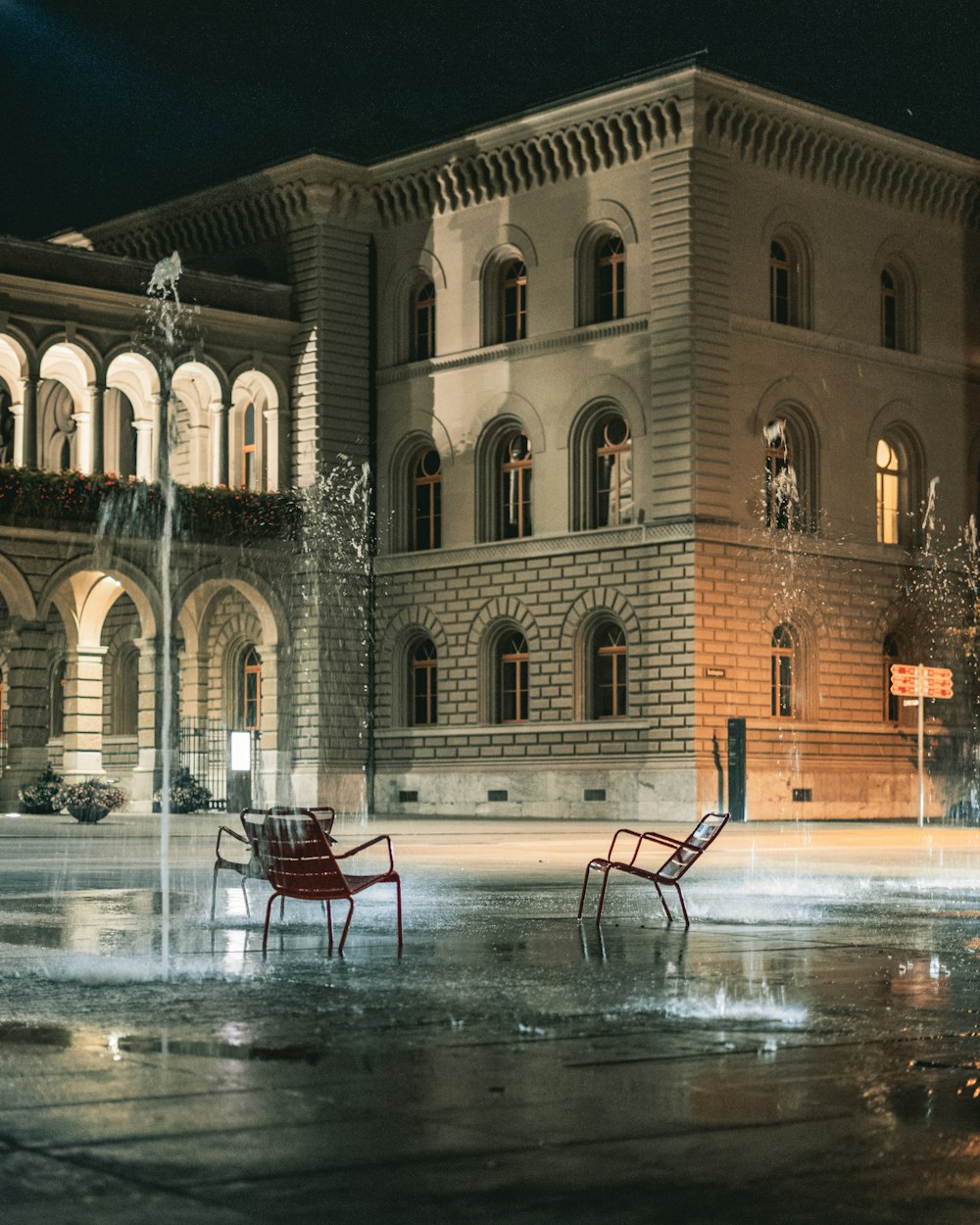 a couple of chairs sitting in front of a building