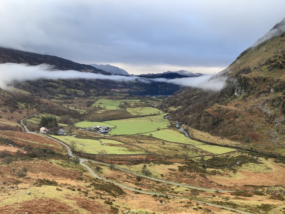 a view of a valley with a road winding through it