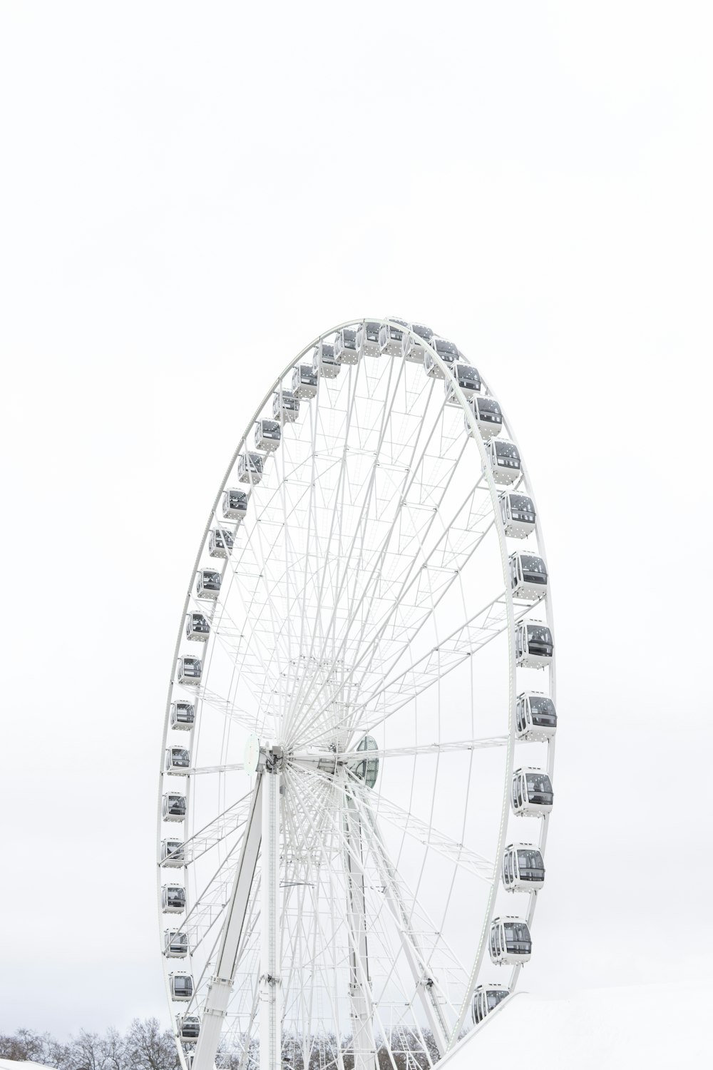a large ferris wheel sitting in the middle of a snow covered field