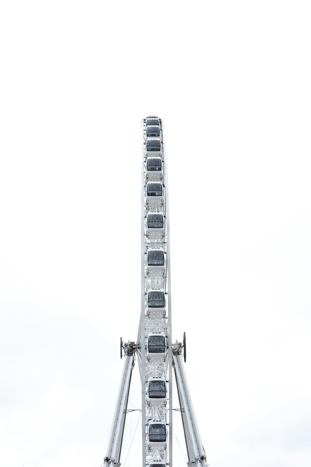 a ferris wheel is shown against a white sky