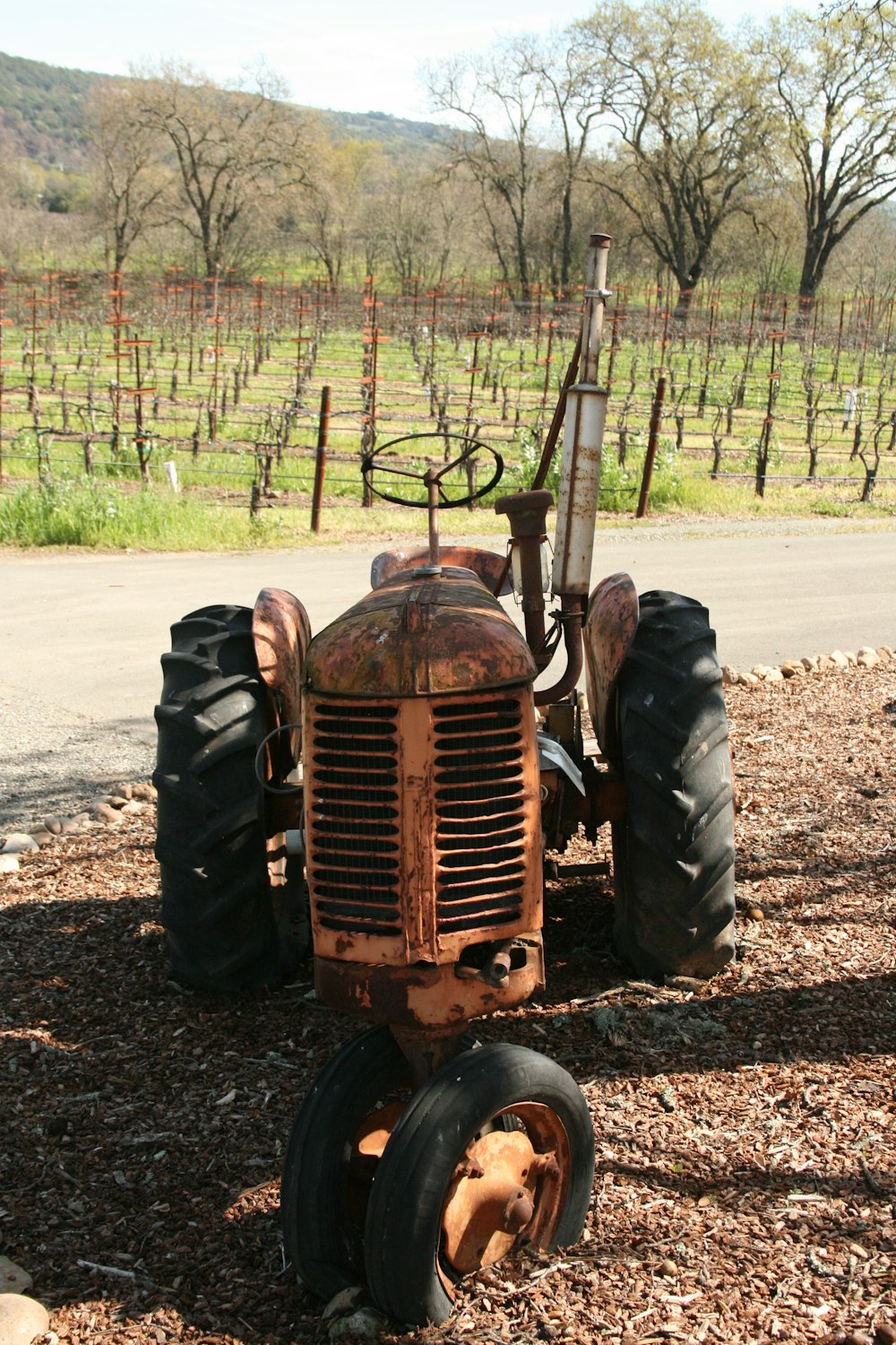 an old rusty tractor sitting in the middle of a field