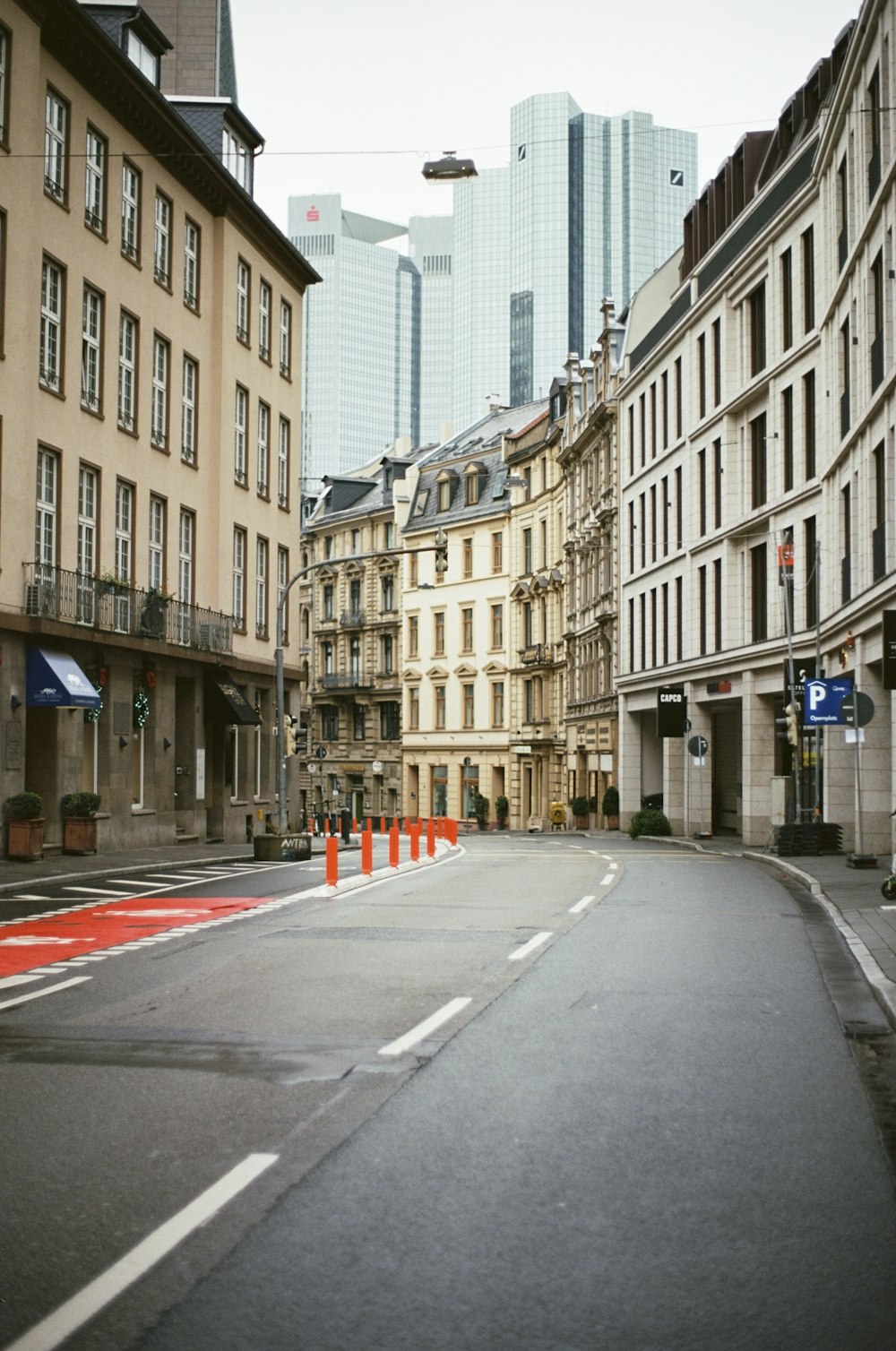 an empty street in a city with tall buildings