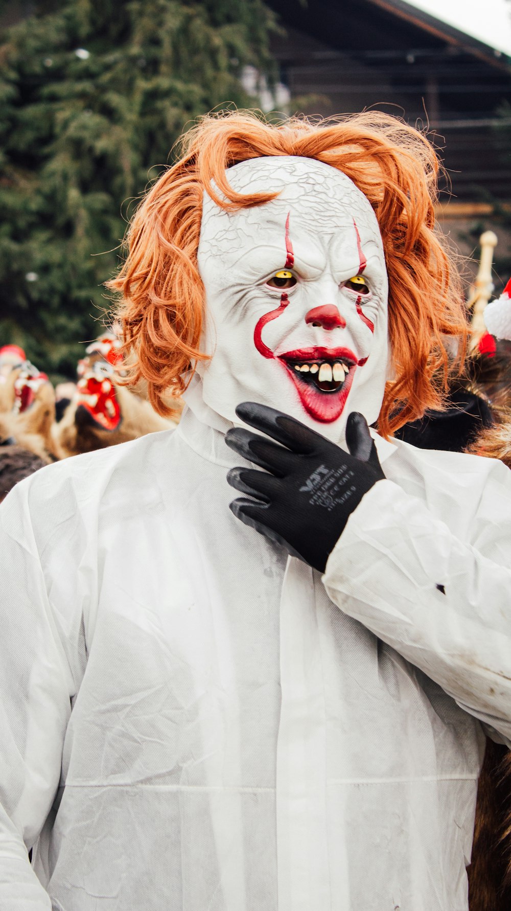 a man dressed as a clown with red hair and makeup