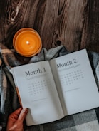 Close-up of hands holding a wellness planner with natural motifs.