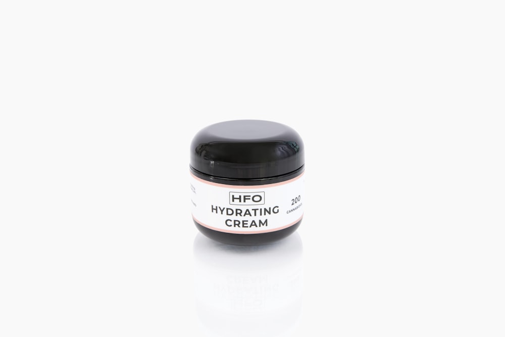 a jar of hfo hydrating cream on a white background