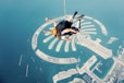 a man flying through the air while riding a parachute