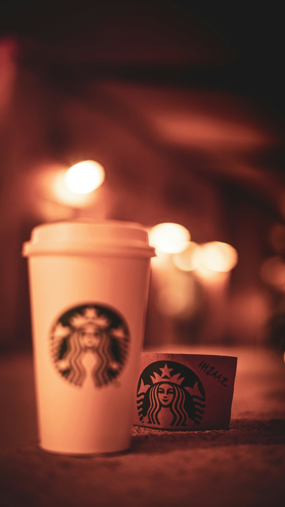 a cup of coffee and a card on a table