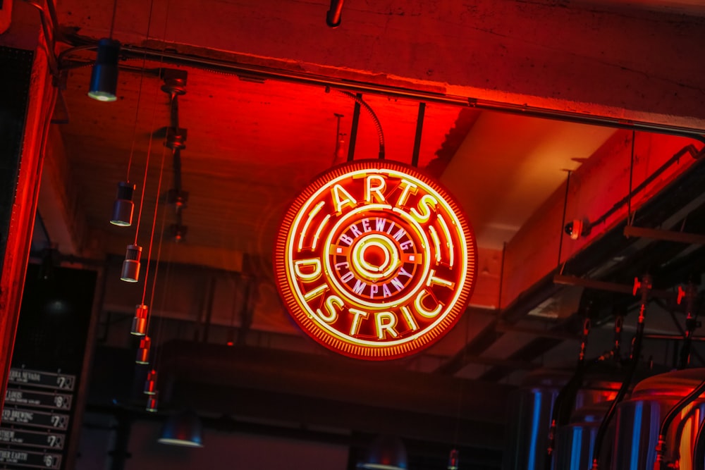 a neon sign hanging from the ceiling of a restaurant