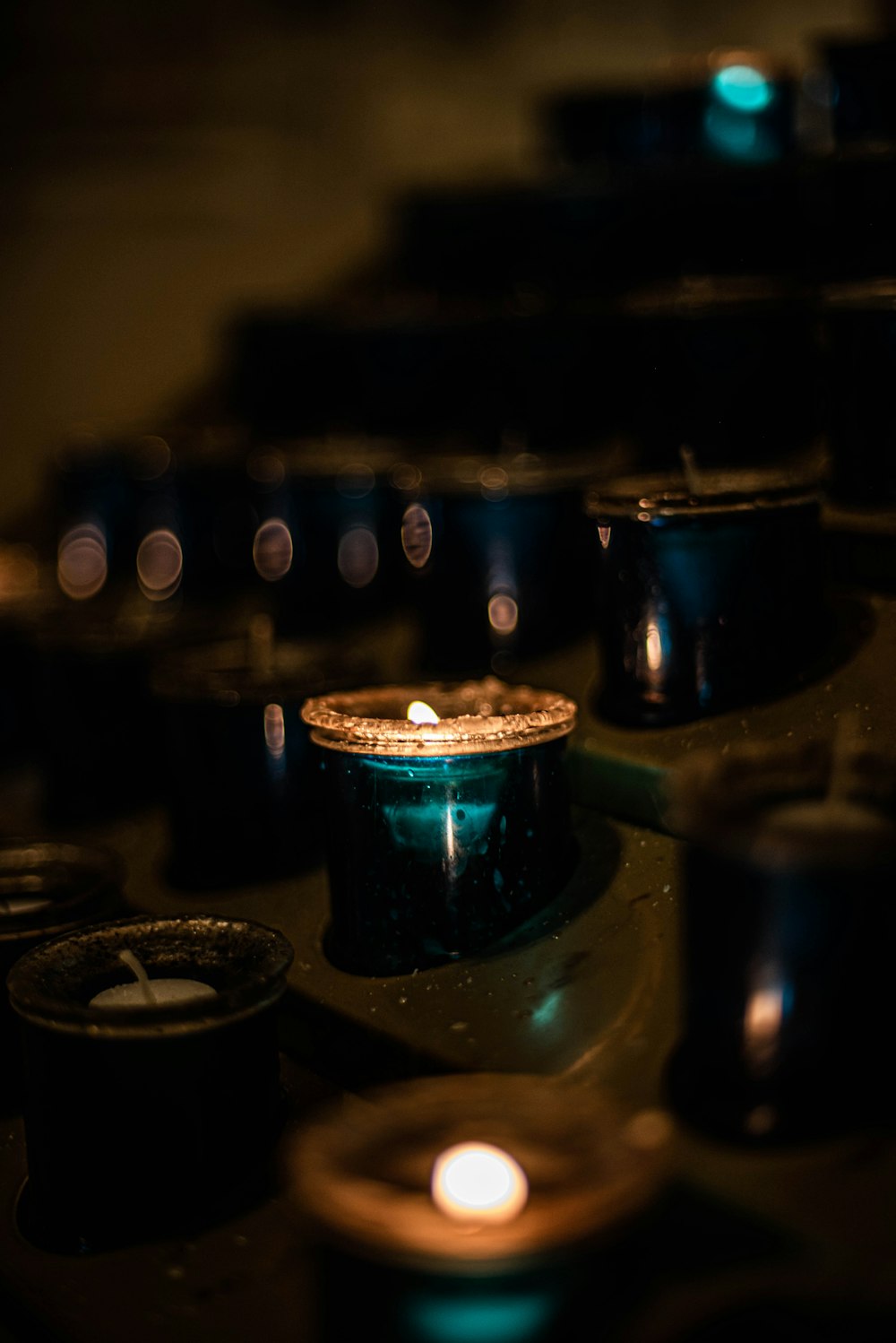 a group of lit candles sitting on top of a table