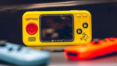 a yellow gameboy sitting on top of a table