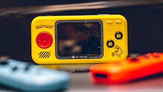 a yellow gameboy sitting on top of a table