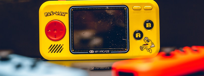 a yellow gameboy sitting on top of a table