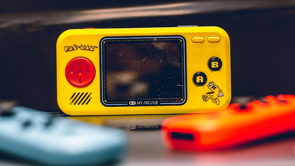 a yellow gameboy sitting on top of a table