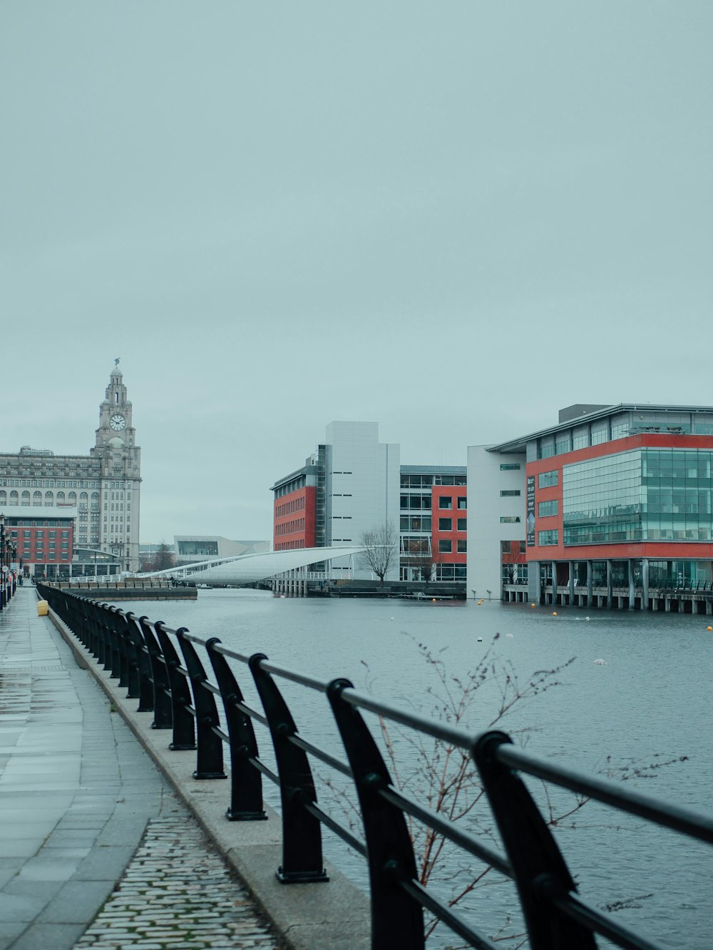 a view of a river with a bridge and buildings in the background