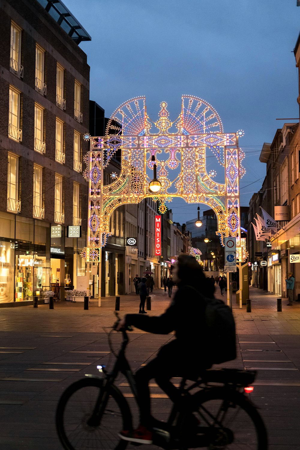 a person riding a bike on a city street