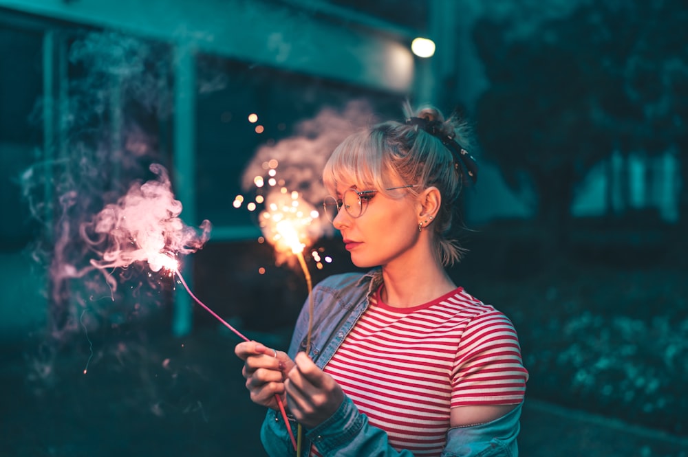 a woman holding a sparkler in her hand