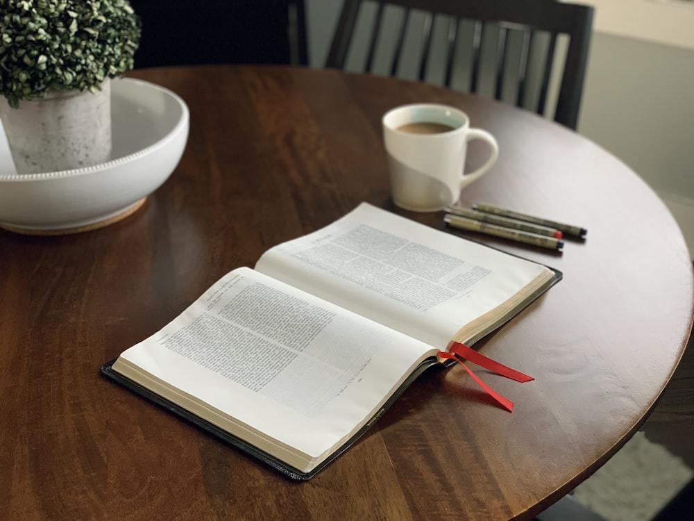 an open book sitting on top of a wooden table