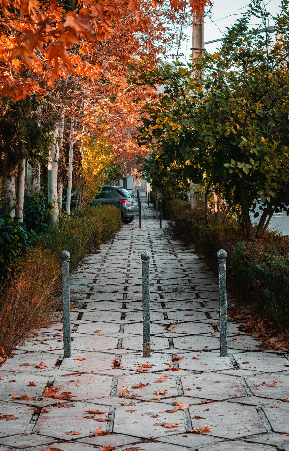 a sidewalk with a car parked on the side of it