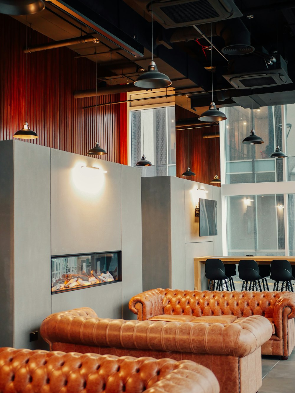 a room filled with lots of brown leather furniture