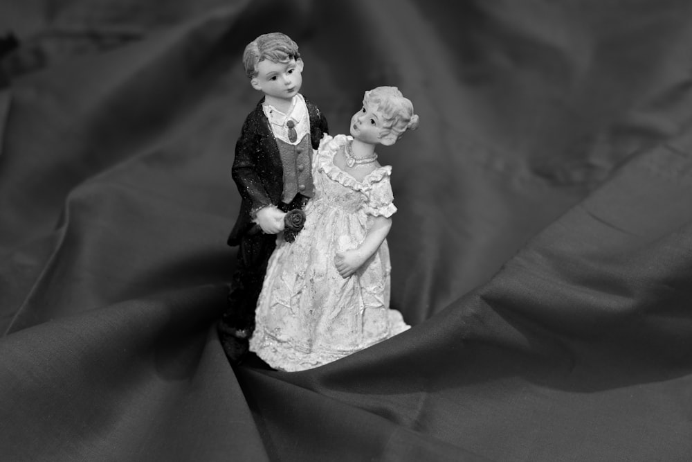 a black and white photo of a couple of figurines