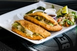 a white plate topped with a sandwich and salad