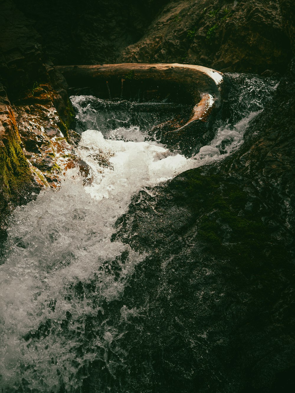 a small stream running through a rocky area