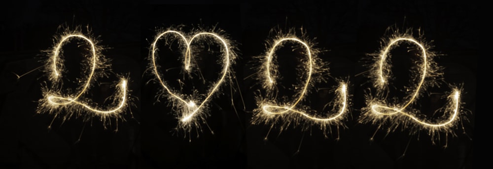 the word love spelled out of sparklers in the dark