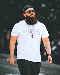 a man with a beard wearing a white shirt