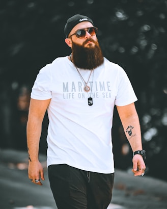 a man with a beard wearing a white shirt