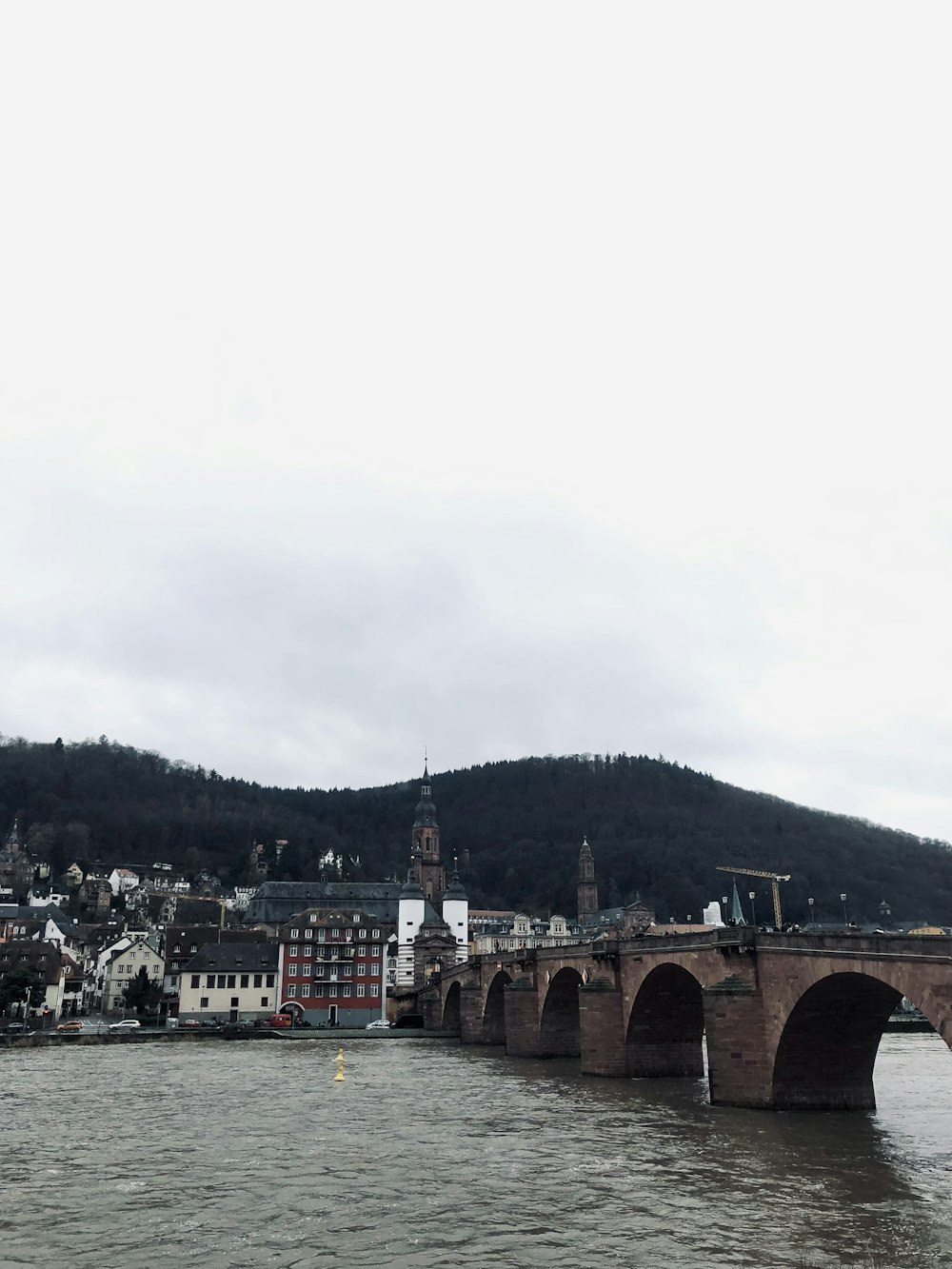 a bridge over a body of water with a city in the background