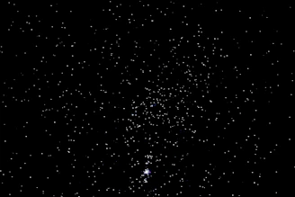 Close-up of a golden foil star map highlighting intricate constellations on a dark background.