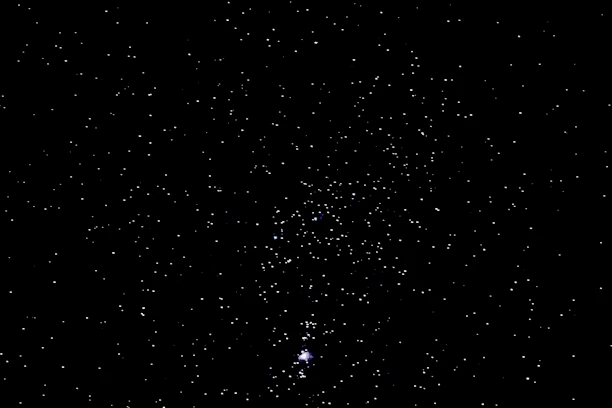 Close-up of a golden foil star map highlighting intricate constellations on a dark background.