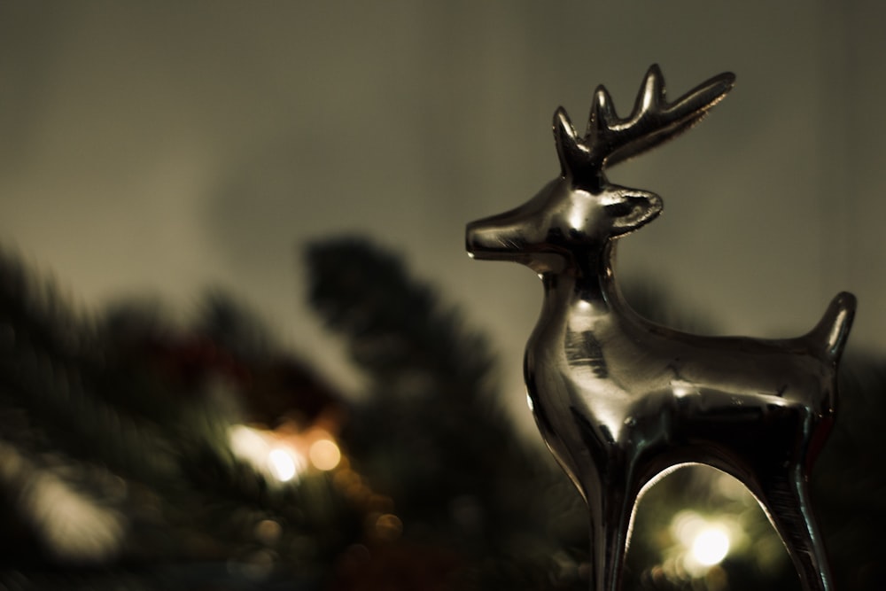 a metal deer statue sitting on top of a table