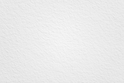Close-up of clean, white slide with subtle textures against a neutral sand-colored background.