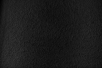 a black textured background with a white border