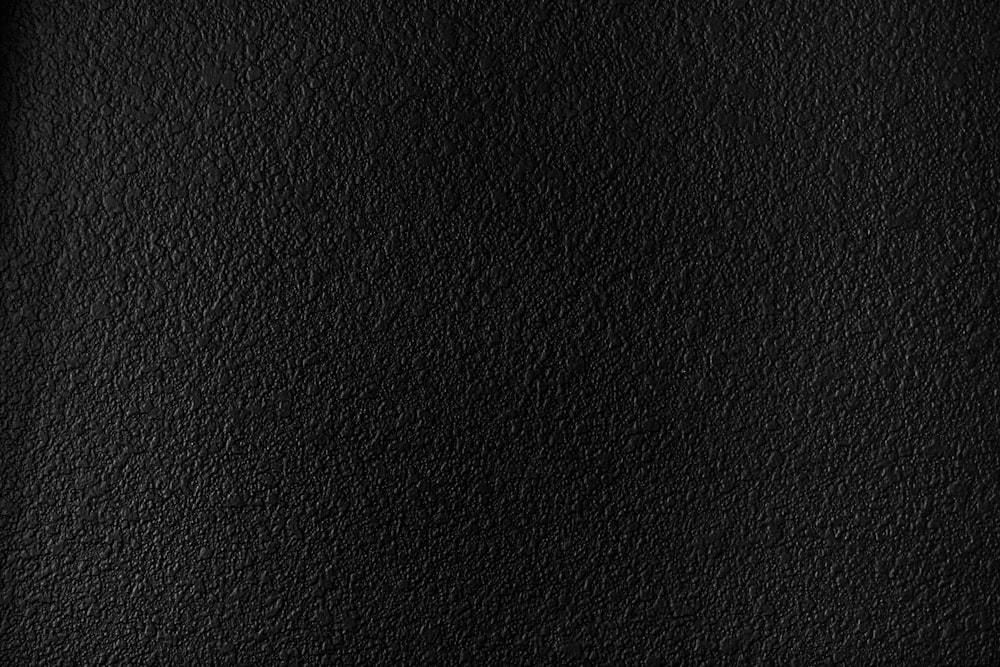 a black textured background with a white border