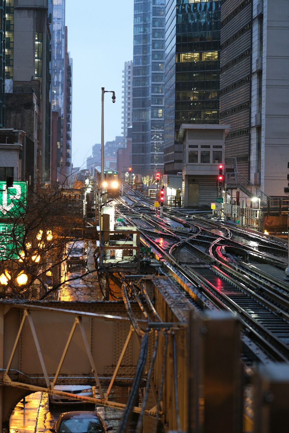 a city street filled with lots of traffic next to tall buildings