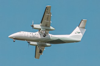 a large air plane flying through a blue sky