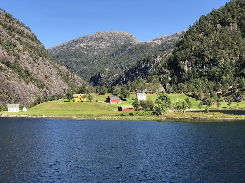 a lake surrounded by mountains and houses