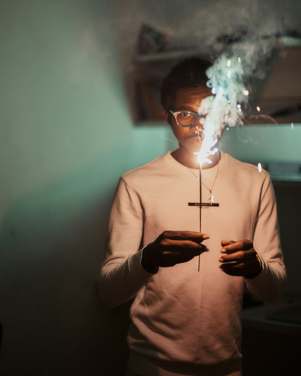 a man holding a lit candle in his hands