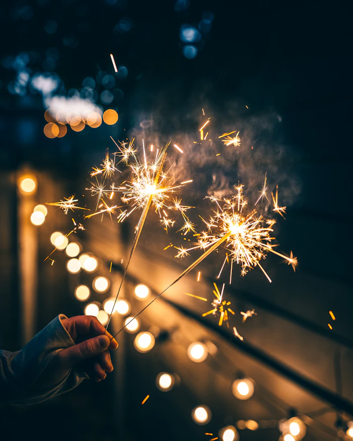 Handheld sparkler alight in the dark