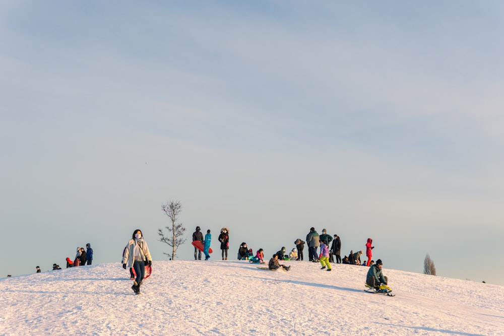 a group of people standing on top of a snow covered slope