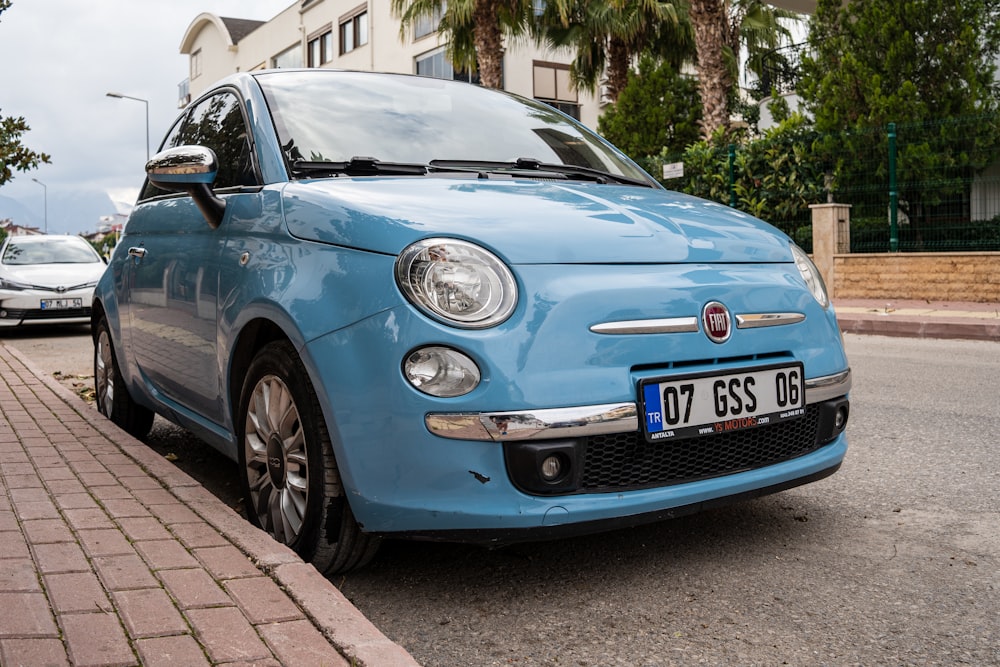 a blue car parked on the side of the road